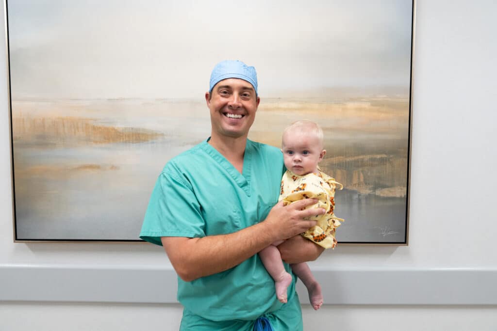 Andrew M. Nida, MD with the first pediatric patient at the new facility